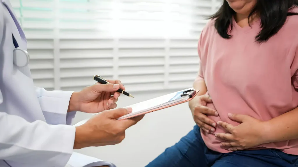 Doctor diagnosing abdominal pain using medical tests such as blood work, ultrasound, and endoscopy for accurate gastrointestinal evaluation